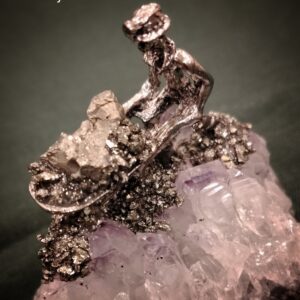 miner statue on pyrite with amethyst stone